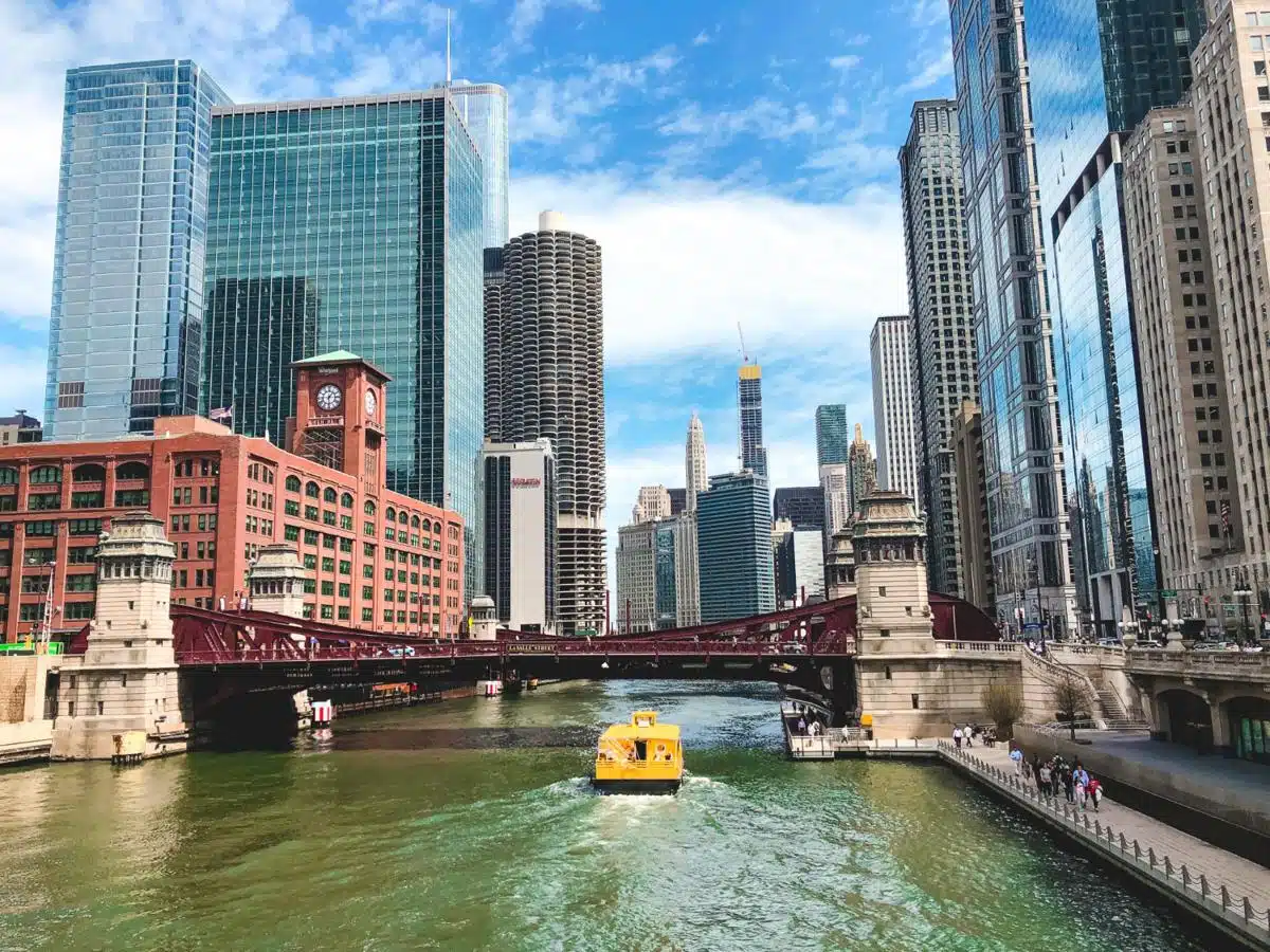 Stunning view of the Chicago River and skyline in Illinois, featuring modern skyscrapers, bridges, and a water taxi.