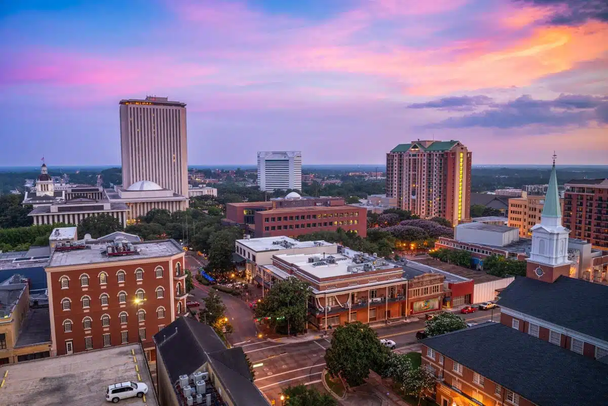 Beautiful view of the Tallahassee, Florida skyline at sunset, featuring government buildings and a vibrant cityscape.