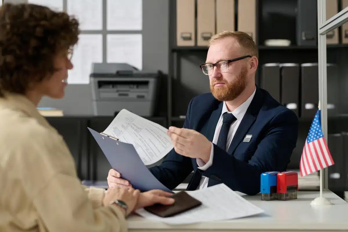 Experienced tax lawyer in Texas discussing legal documents with a client in an office setting.