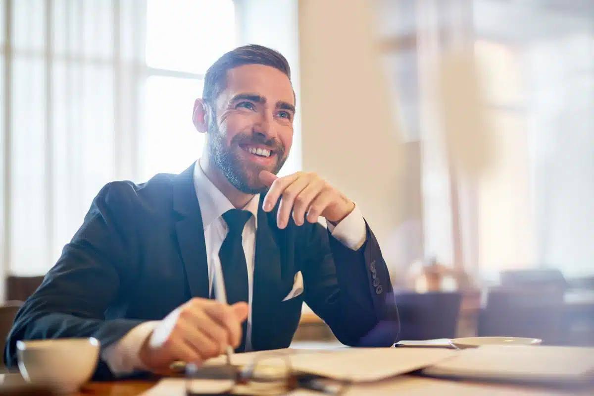 Smiling tax lawyer in New York providing expert legal advice in a professional office setting.