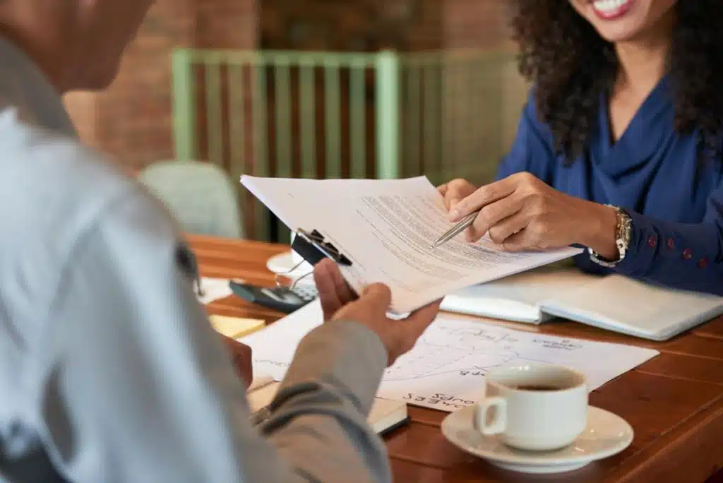 Professional tax lawyer reviewing financial documents with a client at a table in Atlanta