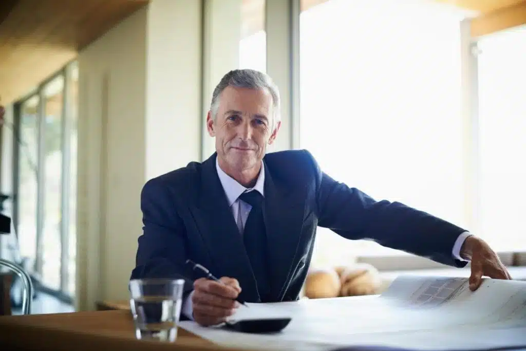 Smiling tax attorney reviewing legal documents in Austin office.