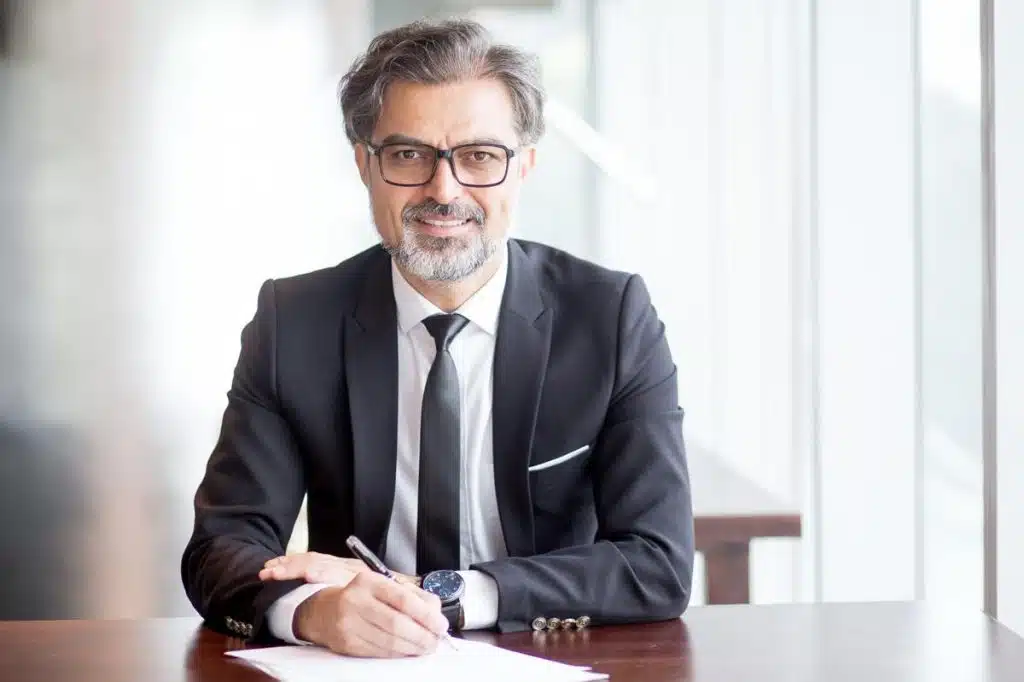 Professional tax attorney in Las Vegas offering expert legal counsel at a modern office desk.