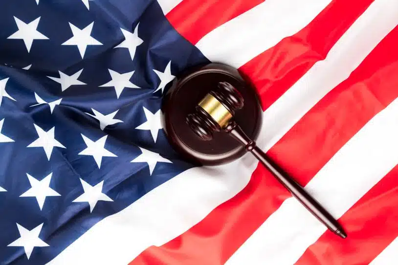 Top view of a judge's gavel on an American flag.